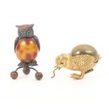 Two bird form novelty tape measures comprising an owl form example in gilt brass and celluloid, on