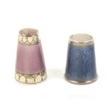 A Norwegian silver and enamel thimble and another, the first with stone top, the body in blue