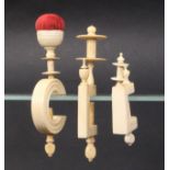 Three 19th Century ivory sewing clamps comprising a turned ïCÍ frame example below a reel and cup