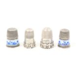 Four thimbles comprising two cable type silver examples one with scroll engraved ïEmilyÍ and two