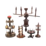 Four reel stands and a wool winder comprising a 19th century turned oak example, 22cm high,