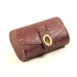 A 19th Century maroon leather tatting box of oval section with brass catch, green paper lined