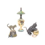 Three metal novelty tape measures comprising an example as an oil lamp with floral painted