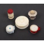 Four pincushions and emeries and a waxer, comprising a small ivory urn form example, 3cm high, a