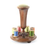 An unusual mid Victorian rosewood reel stand, the circular base on three bun feet with six reel