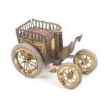 A rare gilt brass novelty tape measure in the form of an open top car, ïquilted seatÍ, rubber tyres,