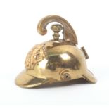 A rare brass novelty tape measure in the form of a firemanÍs helmet complete tape wound from the