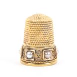 A Victoria heavy gold thimble the frieze set with six pearls in square mounts divided by wirework