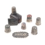Six silver thimbles and two other items, comprising six silver thimbles one with stone top, one in