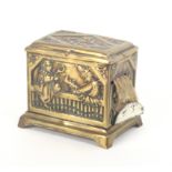 An embossed brass tape measure as a hurdy gurdy of rectangular form the front with Punch and Judy,