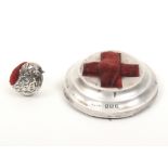 Two silver pincushions comprising a circular example with inset velvet red cross, Birmingham,