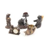 Five carved wooden Tyrolean sewing bears comprising an example on its back holding a brass bin bowl,