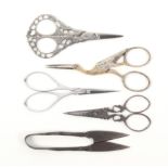 Five pairs of steel scissors comprising a pair with pointed tapering triangular blades, the arms