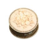 A fine 19th Century carved ivory disc form pincushion each side carved with a variant panel in
