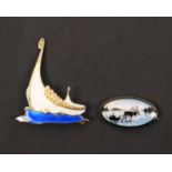 Two Norwegian enamel and white metal brooches, comprising an example as a Viking ship on blue waves,