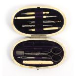 An oval tortoiseshell etui by Lund, circa 1880, the lid with silver oval, the interior in purple