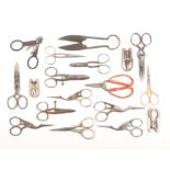 A collection of scissors comprising four folding pairs, a pair with silver handles, four pairs of