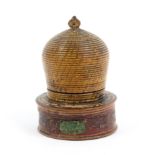 A painted Tunbridge ware pin cushion in the form of a bee skep, on screw off box form base with