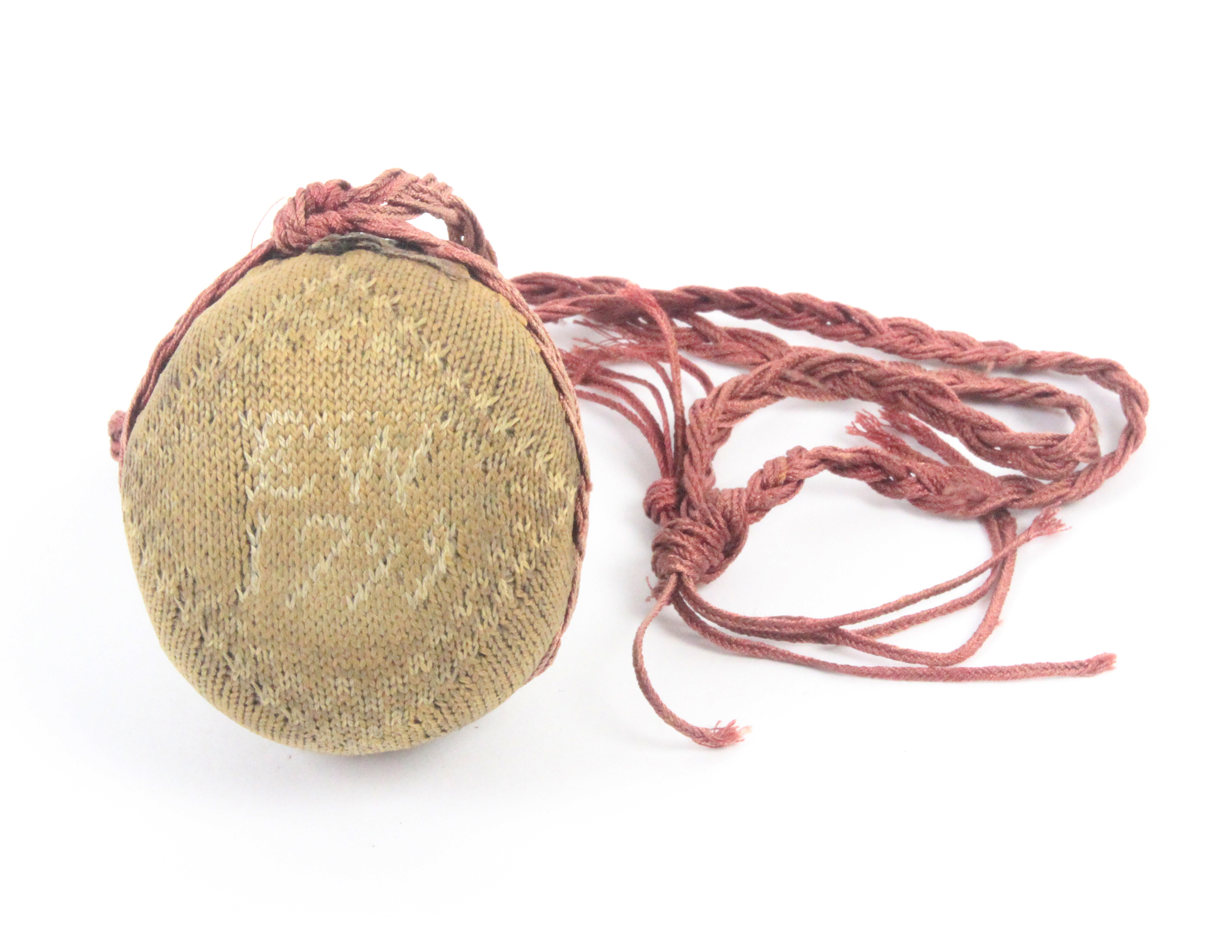 An 18th Century dated knitted pin ball, one side depicting a three masted sailing ship, the other