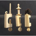 Three 19th Century ivory sewing clamps each with a rectangular frame, one with reel, one with pin