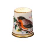 A 19th Century English porcelain thimble attributed to Worcester painted with a bird on a
