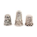 Three Indian Kutch silver thimbles, the first of tall form with punched sides and top over a