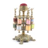 A mid Victorian brass reel stand, the leaf and paw cast base below three elaborately pierced tiers