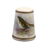 A Royal Worcester puce mark thimble painted with a bird amid flowers between gilt lines and signed