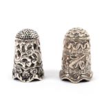 Two Indian Kutch silver thimbles the first decorated with flowers and leaves over a conforming