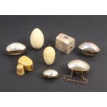 Eight thimble cases comprising four mother of pearl egg form examples with gilt hinge mounts, two