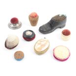 Nine pin cushions, including a leather pumpkin, 25cm, a circular silver example, a soft metal shoe