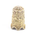 A fine Indian Kutch silver gilt thimble of tall form finely decorated with leaf scrolls and