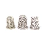 Three Indian Kutch silver thimbles, the first with triangular and stiff leaf triangular panels