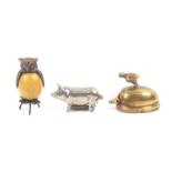 Three metal novelty tape measures, comprising a plated standing pig, complete printed tape in ins,