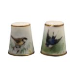 Two Royal Worcester porcelain puce mark thimbles, the first painted with a bird within gilt lines