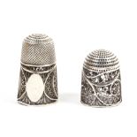 Two 19th Century English silver filigree thimbles, the first with oval vacant cartouche within quill