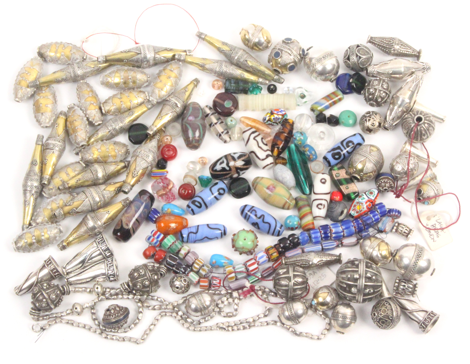 A collection of beads, comprising Eastern silver and white metal examples of elaborate form together