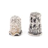 Two Indian Kutch silver thimbles, the first of tall form with a band of leaves and beaded frieze,