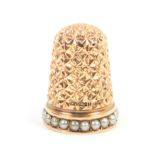 A gold thimble by Charles Horner, the frieze set with a band of pearls, Reg. No. 127-211 (1889)