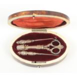 An oval tortoiseshell sewing box, circa 1820, white metal escutcheon, on four bone bun feet, the red