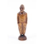 A carved boxwood standing figural needlecase, the male figure wearing tail coat, his hands in his