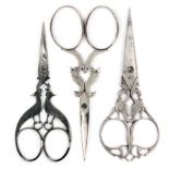 Three pairs of 19th Century steel scissors, comprising a pair the arms as birds above oval loops,