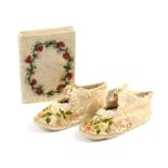 A pair of 19th Century silk baby’s shoes and a notelet/wallet, the floral silk shoes embroidered