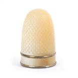 A 19th Century French mother of pearl thimble, the plain frieze enclosed by gilt borders Internal