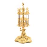 An exhibition quality gilt brass mid-Victorian reel stand, the scroll and leaf decorated triform