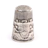 A late 19th Century French silver pictorial thimble, the frieze with two seated women beside a