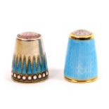 Two Norwegian silver and enamel thimbles comprising a stone top example with blue enamel peaks