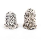 Two Indian Kutch silver thimbles, first with deep floral leaf scrolls over an undulating rim, the