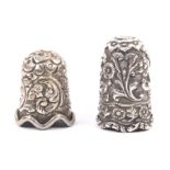 Two Indian Kutch silver thimbles, the first with flower top over deep scrolling leafy branches and