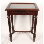 A reproduction mahogany finish table vitrine, hinged glazed panel, over a carved frieze on turned